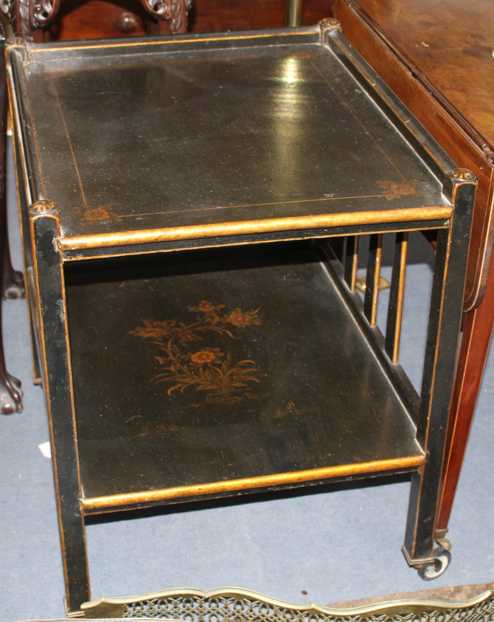 A 1920s black lacquered two tier trolley, with gilt floral decoration, W.63cm D.55cm H.71cm